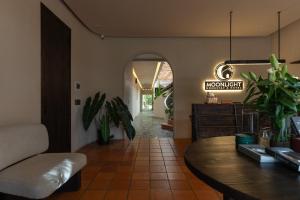 a living room with a table and some plants at MOONLIGHT Homestay & Hotel in Pleiku