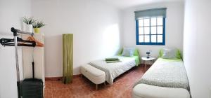 una stanza con due letti e una finestra di Casa Luz a Costa Calma