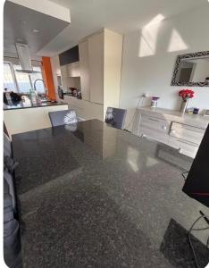 a kitchen with a large glass table in a room at Chez Soiz in Guipavas