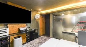 a bedroom with a large screen tv and a bed at Jukdo market G1mini in Pohang +63 photos