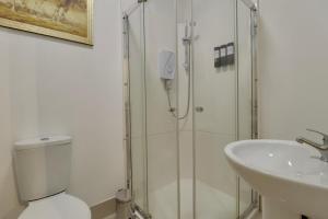 a bathroom with a shower and a toilet and a sink at Aylward Queen Street, Studio Apartment Near City Centre, Gunwharf Quays in Portsmouth +23 photos