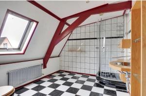 a bathroom with a shower and a checkered floor at Sfeervolle kamer aan de Dorpsdijk met Gratis Ontbijt in Lobith