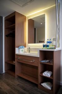 a bathroom with a sink and a mirror at Campanile Xi'an Bell Tower Huimin Street in Xi'an
