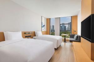 a hotel room with two beds and a flat screen tv at Fairfield by Marriott Hangzhou Future Sci-tech City in Hangzhou +41 photos