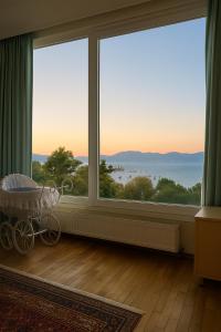 a room with a large window with a view of the ocean at Caecilia & Lawrence Organic Mediterranean Sea Villa in Chalkida
