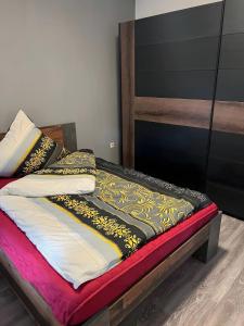 a bed in a room with a wooden headboard at Apartament in Bürstadt