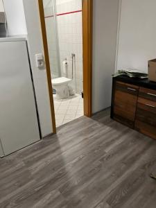 an empty bathroom with a toilet and a sink at Apartament in Bürstadt