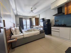 a bedroom with a large bed in a kitchen at RESTEL STUDIO FLATS in Hyderabad