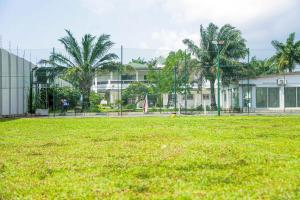 a large grass field in front of a building at Bethesda in Marcory