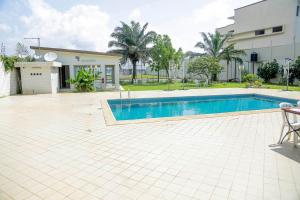 a swimming pool in front of a house at Bethesda in Marcory
