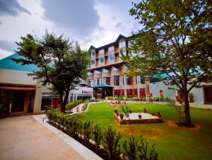 a large building with a garden in front of it at Sterling Manali in Manāli
