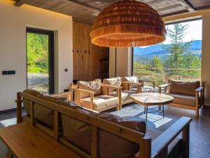a living room with a couch and a table at Eho Resort in Ilʼtsya Gurny