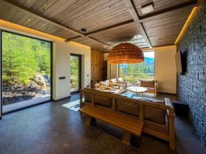 a living room with a bench and a stone wall at Eho Resort in Ilʼtsya Gurny