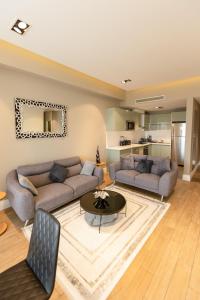 a living room with two couches and a table at The Pearl In City by WOW Property - Direct from developer in Accra