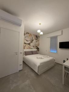 a bedroom with a bed and a stone wall at Da Marianna in Castelnuovo Rangone