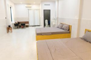 En eller flere senge i et værelse på Happy House Sài Gòn + 35 billeder