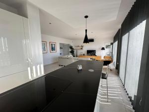 ein Wohn- und Esszimmer mit einem schwarzen Tisch in der Unterkunft Villa Martin AV-88 in Montjoys