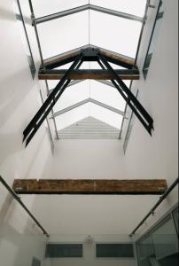 a ceiling in a room with a metal frame at Gibson Mill waterfront warehouse apartment - 101 in Hobart +30 photos