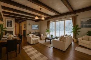 a living room with white furniture and a table at Bellevue Beam House in Covasna