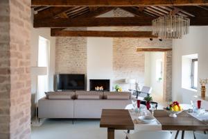 a living room with a couch and a fireplace at Attico Malatesta in Rimini