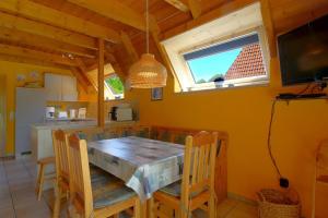 una cucina e una sala da pranzo con tavolo e sedie in legno di SV2 Knechtsand 16 a Dorum-Neufeld