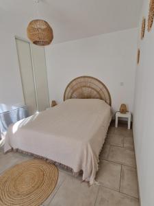 a bedroom with a bed and a tiled floor at Au bout du chemin Chez Tina in Sarrians +24 photos