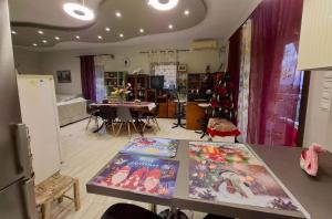 a living room with a table with paintings on it at Eretria Panorama Seaview Retreat with Balcony in Eretria