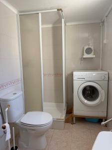 ein Badezimmer mit Toilette und Waschmaschine in der Unterkunft Casa Almoinha in Sesimbra + 3 Fotos