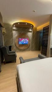 a hotel room with a bed and a flat screen tv at Hotel Four Season - Gomtinagar - Lucknow in Lucknow