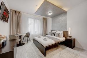 En eller flere senge i et værelse på L'Heritage Collection Romana Apartments