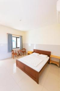 a bedroom with a large bed in a room at Bảo Lộc Hotel Lagi in La Gi