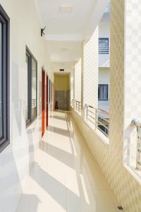 an empty hallway of a building with red doors at Bảo Lộc Hotel Lagi in La Gi
