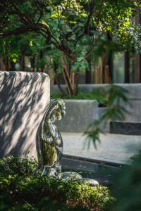 a statue of a bird sitting on top of a fountain at XIN HOTEL in Hangzhou