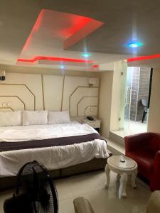 a bedroom with a large bed and a red light at 111Suites&Lounge in Aba