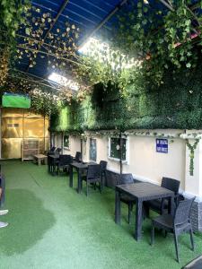 a room with tables and chairs and plants on the wall at 111Suites&Lounge in Aba