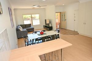 a kitchen and living room with a table and chairs at Griffith Prestige Apartment in Griffith