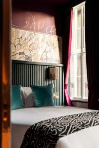 a bedroom with a bed and a window at The Wellington Hotel in London