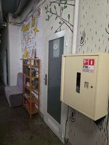 a room with a door and a shelf of shoes at The Hostel in Kyiv +10 photos