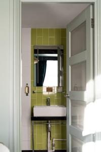 a bathroom with a sink and a mirror at The Wellington Hotel in London +89 photos