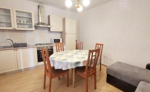 a kitchen with a table and chairs in a room at Apartments Dara in Umag