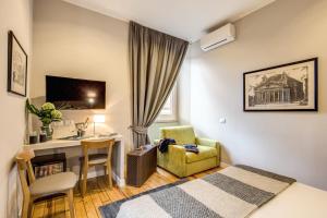 a hotel room with a bed and a desk and a chair at The Club Navona in Rome
