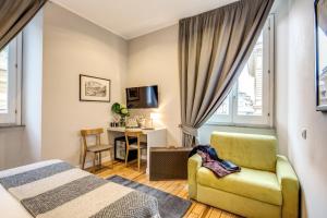 a bedroom with a bed and a chair and a desk at The Club Navona in Rome