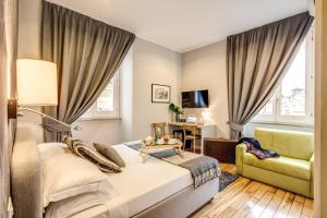 a hotel room with a bed and a chair at The Club Navona in Rome
