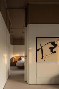 a painting on a wall in a hotel room at XIN HOTEL in Hangzhou +105 photos