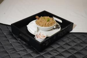 a black box with a bowl of rice and a plate of food at Blessings Prime Porur - Near DLF in Chennai