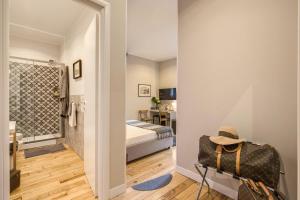 a room with a bedroom with a bed and a mirror at The Club Navona in Rome