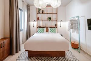a bedroom with a large bed and a chandelier at Next door Athens in Athens