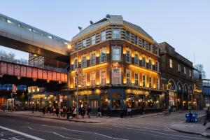 a building on a street with people walking on the street at The Wellington Hotel in London