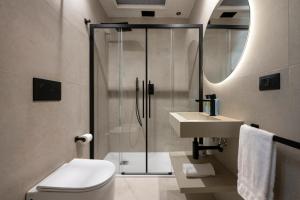 a bathroom with a shower and a toilet and a sink at Boutique Hotel Travé Rome City Centre in Rome