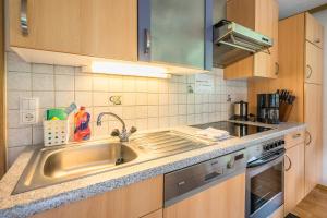 a kitchen with a sink and a stove at Haus Tramontana in Gaschurn